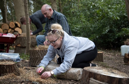 Lady learning to wood carve'